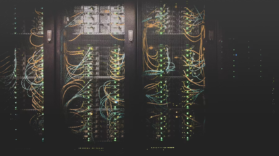 Data center server racks with complex cable infrastructure supporting diverse roles across networking operations and facilities management